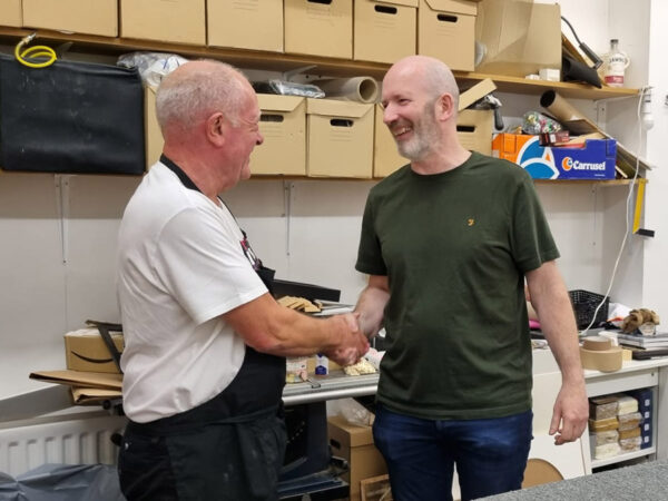 Denis shaking hands with Ian after passing